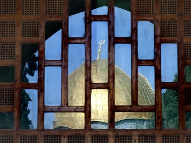 The Dome of the Rock is reflecting on the main gate of the Al-Aqsa mosque inside the Al-Aqsa mosques compound, sacred for Muslims and Jews, in Jerusalem's Old City, on November 3, 2015.