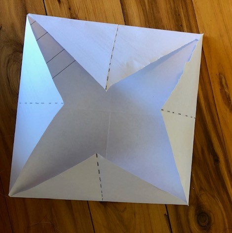 Each right angle folded to the centre of the square.