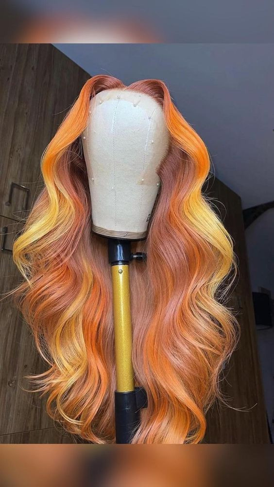 Boldly colored wigs on a wig stand