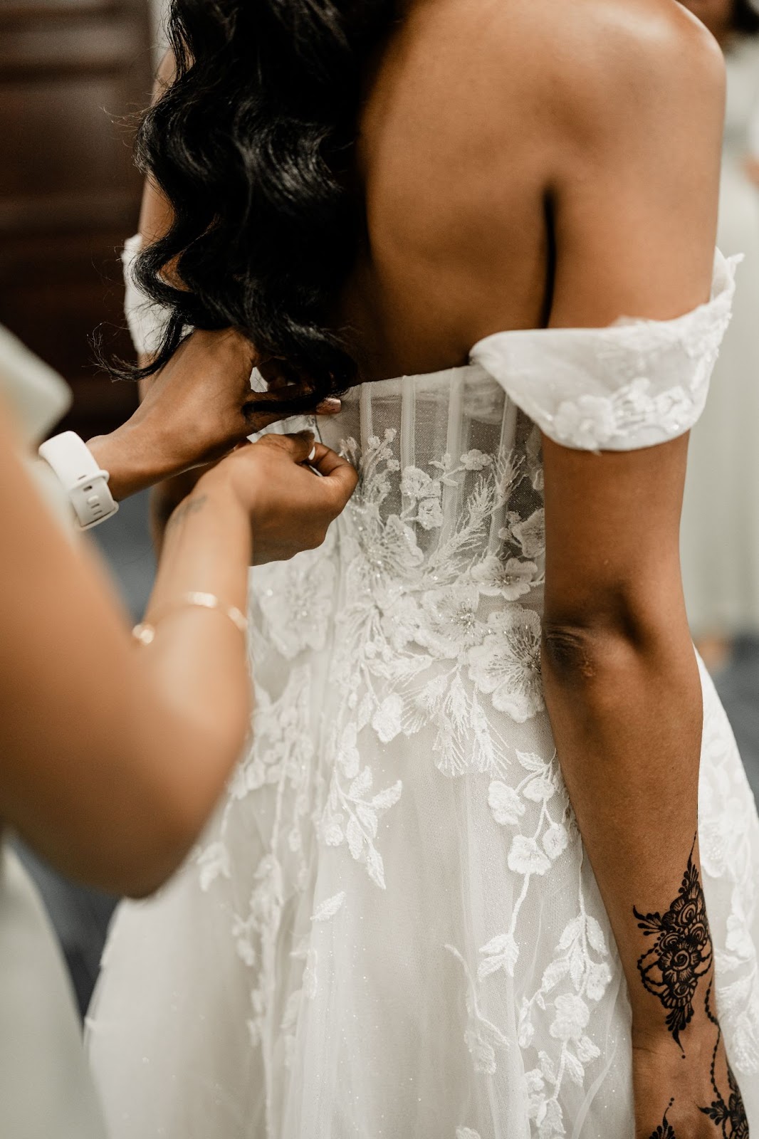 Bride's dress being zipped up