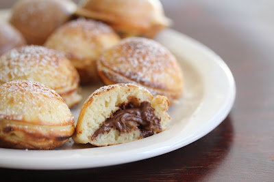 photo of aebleskivers with one sliced in half with Nutella inside