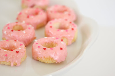 photo of mini donuts with pink icing on a plate