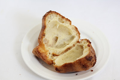 close-up photo of a bacon popover sliced in half to show the airy interior