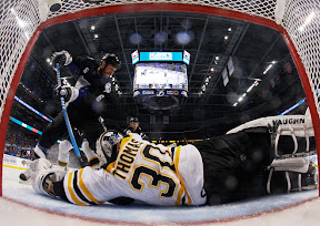 Bruins Tim Thomas make a save against Lightning's Ryan Malone Bruins Tim Thomas make a save against Lightning's Ryan Malone