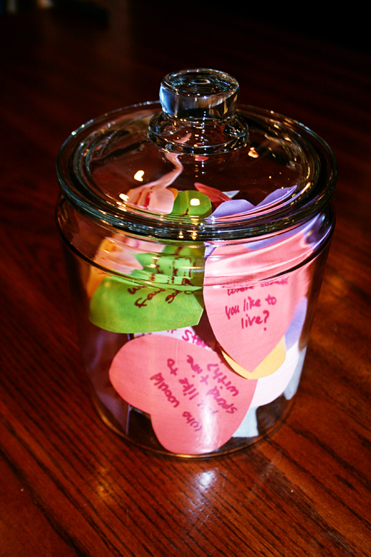 glass jar filled with colored hearts and hand-written questions