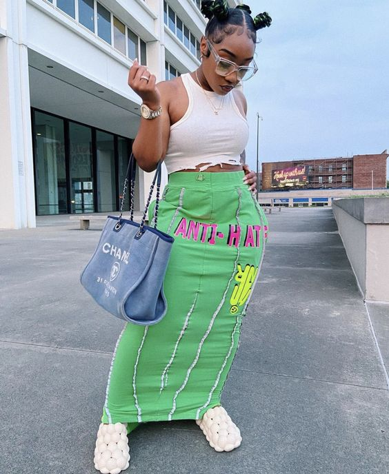 a girl rocking a long skirt with bantu knots hairstyle