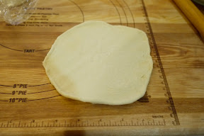 photo of a naan dough rolled out and ready to bake
