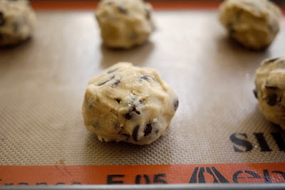 photo of a cookie dough ball on a baking sheet