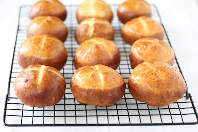 pretzel rolls cooling on a baking rack