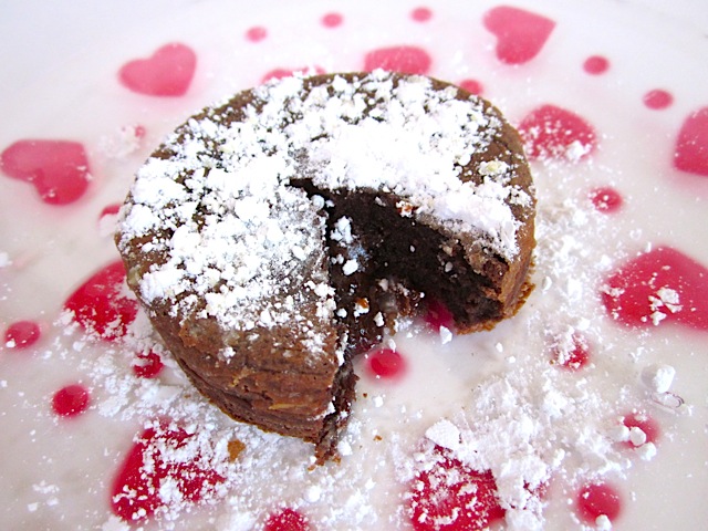 chocolate lava cake on heart plate with piece cut out 