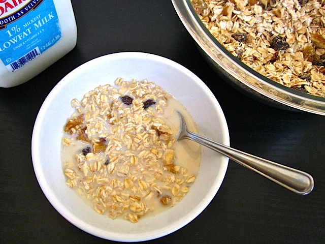 muesli in white bowl with milk poured over top 