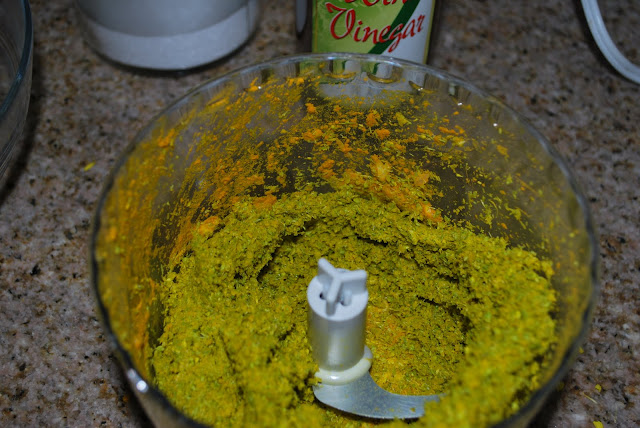 Food processor 3 This is an image of a food processor with ground spices and mustard flowers in it.