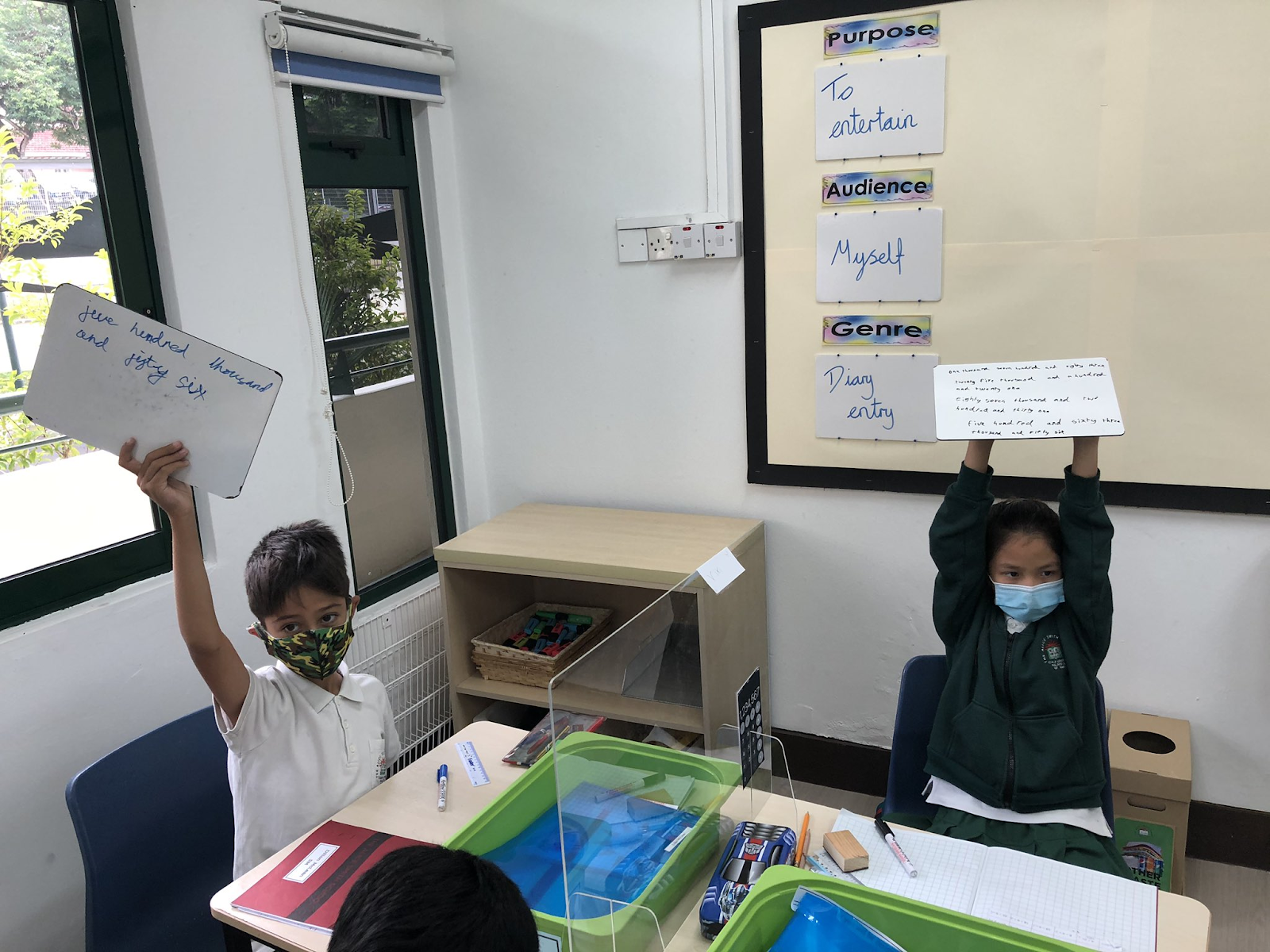 Children with whiteboards