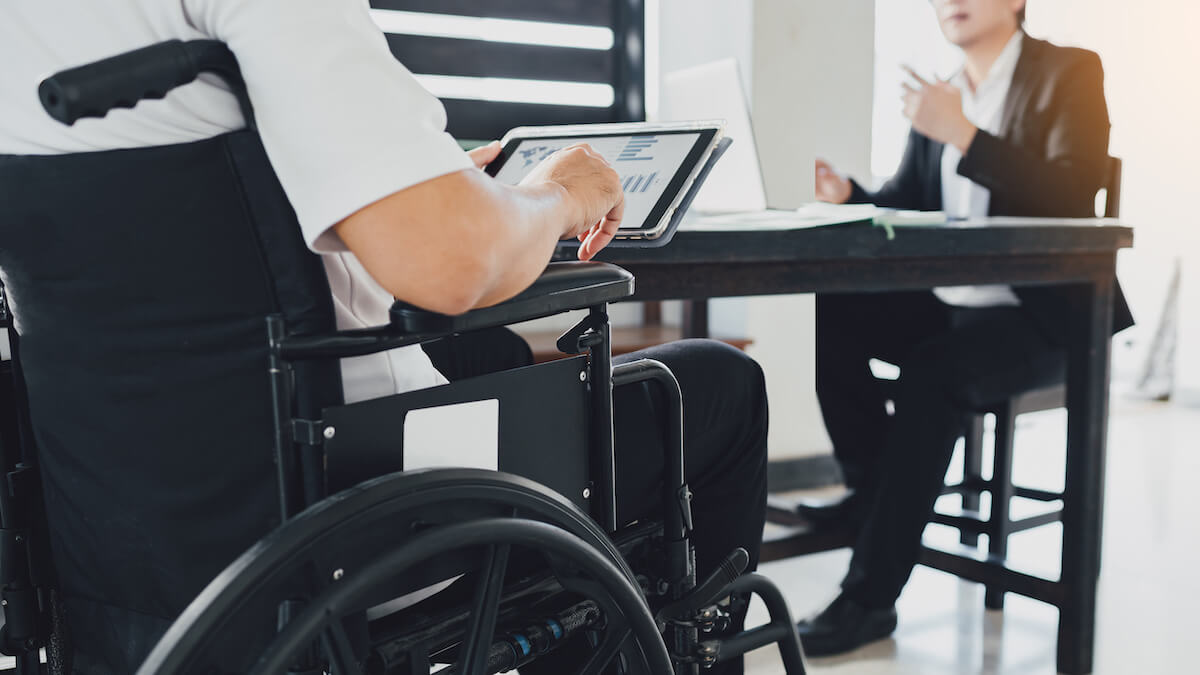 FMLA California: person in a wheelchair using a tablet