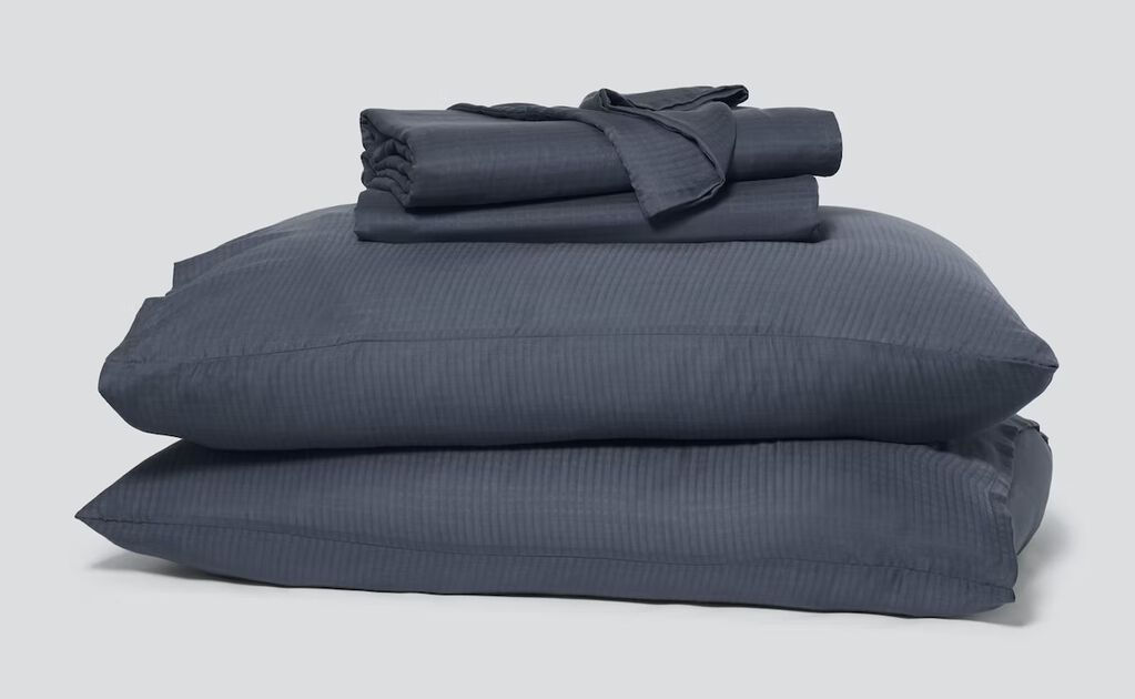 Stack of dark gray sheets and pillows