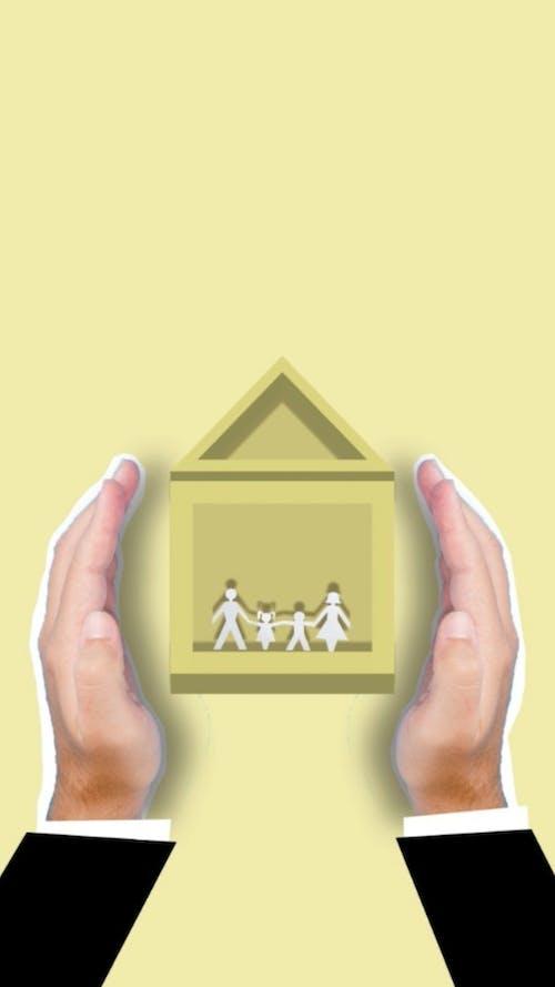 Free Creative image of cutout faceless person showing vector house image with family members inside Stock Photo