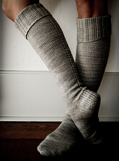 person wearing knit knee high socks with ribbed cuffs