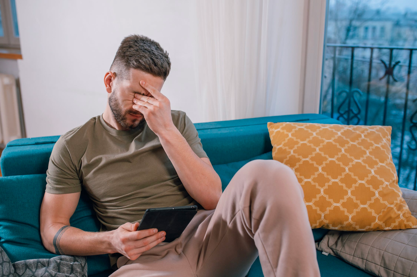 A frustrated man looking at a tablet