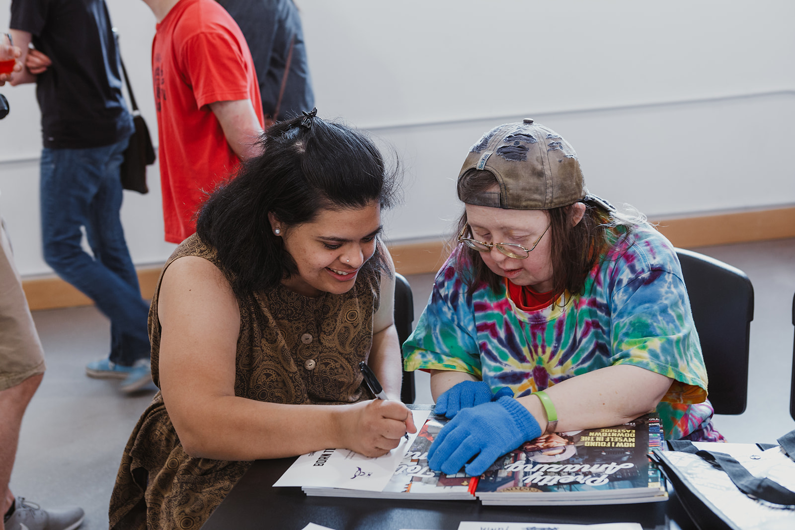 Friends Rosh and Teresa make notes on Teresa's Born To Represent cards. Photo: This Is It Studios.