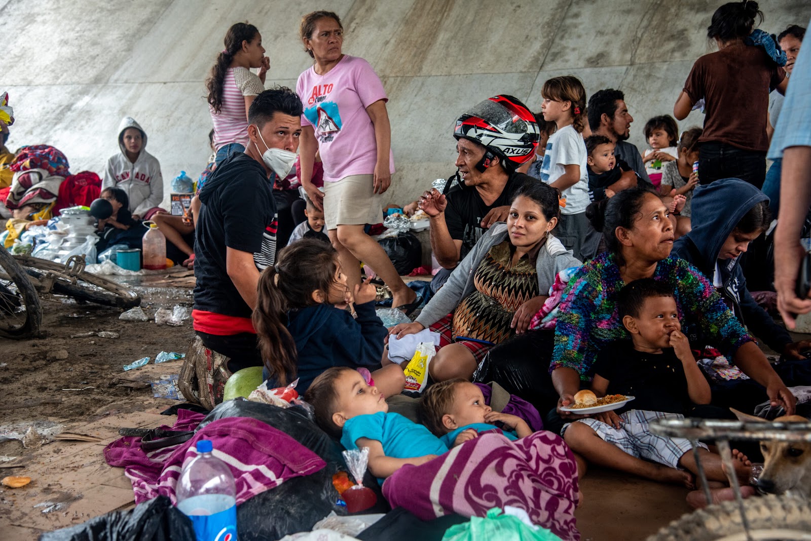 People who were forced to abandon their homes in the San Pedro Sula Valley due to floods in the aftermath of Hurricane Eta take refuge in a makeshift camp underneath an overpass in Chemelecon. Credit: Seth Sidney Berry/SOPA Images/LightRocket via Getty Images