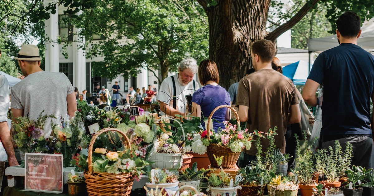 An outdoor flower market in Louisville bustling with people