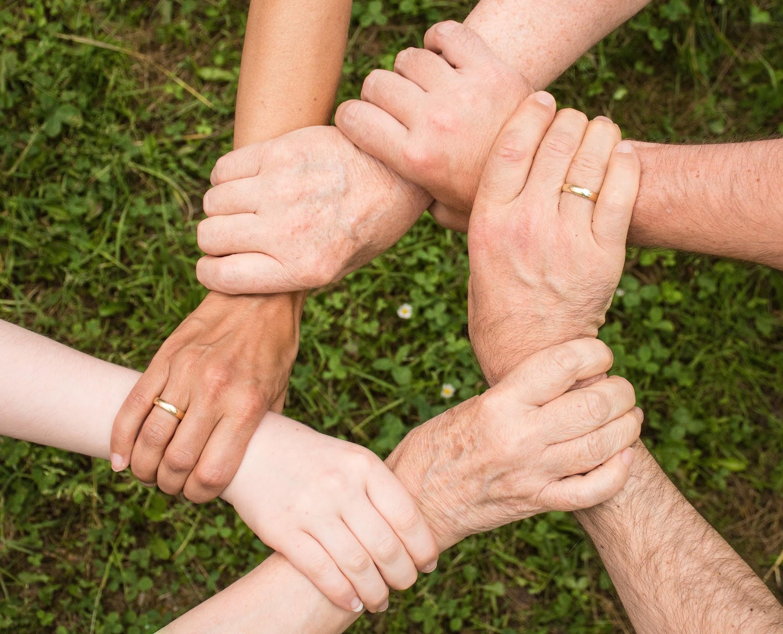 six hands holding each other