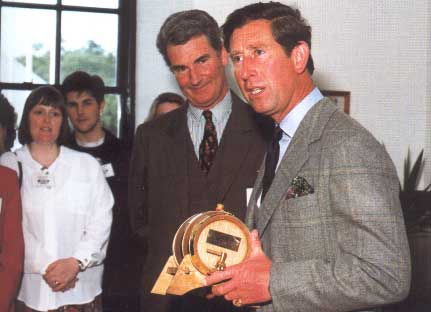 Prince Charles with a miniature barrel of Laphroaig, which surprisingly relates to migrating to SaaS in telecom