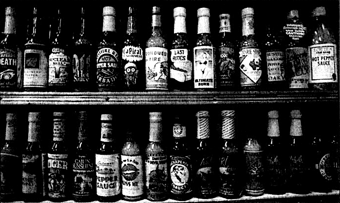 black and white newspaper photo of two shelves filled with small bottles