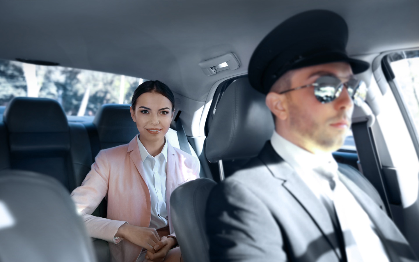 woman sit in car with chauffer 