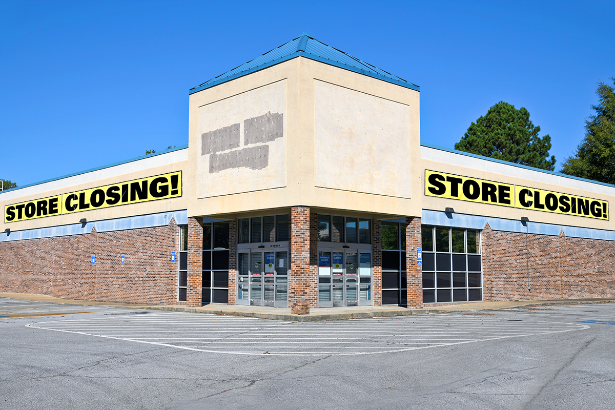 image of empty store with "store closing sign" 