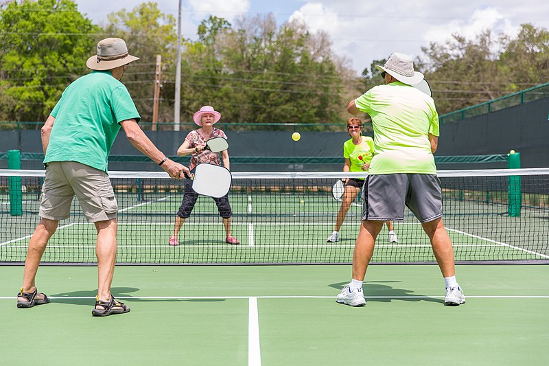 A game of pickleball doubles with both teams standing at the non volley line