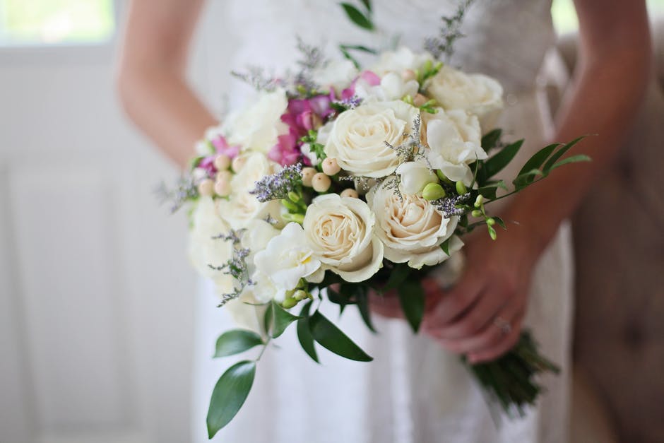 Bride Holding White Bouquet of Roses