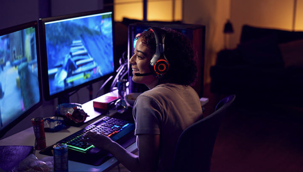 Girl is playing in computer games with headphones