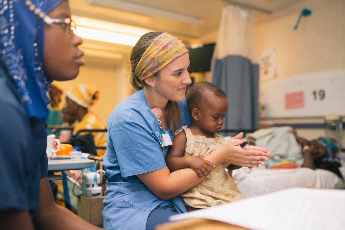 a nurse holding a baby 