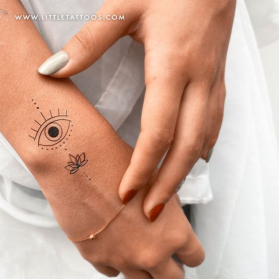 A close up view of the tatoo design on the wrist of a lady