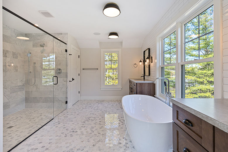 bathroom-with-light-gray-and-white-hexagon-tile-floor-with-large-walk-in-shower-and-soaker-tub