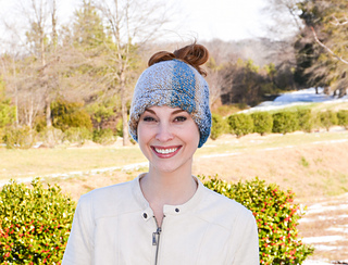 woman wearing knitted messy bun hat outside