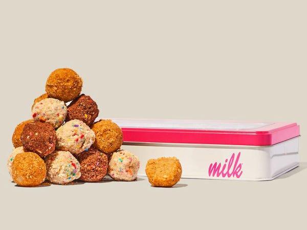 cake truffles stacked upon each other and pink and white tin with text "milk"