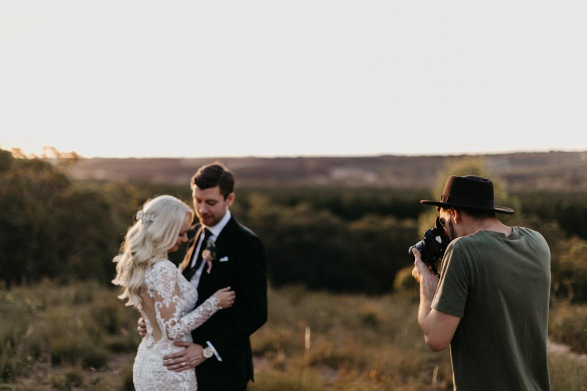 A photographer capturing the bride and groom