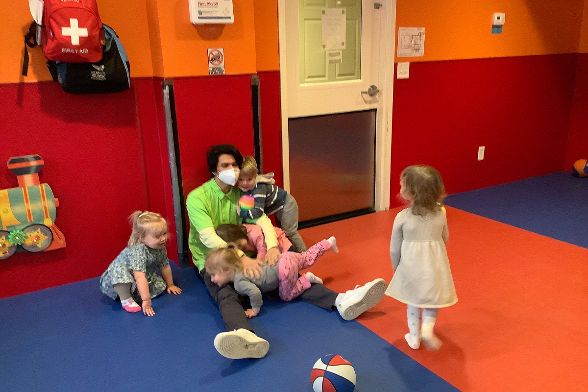 casa teacher mr. efren playing with children during gym time.