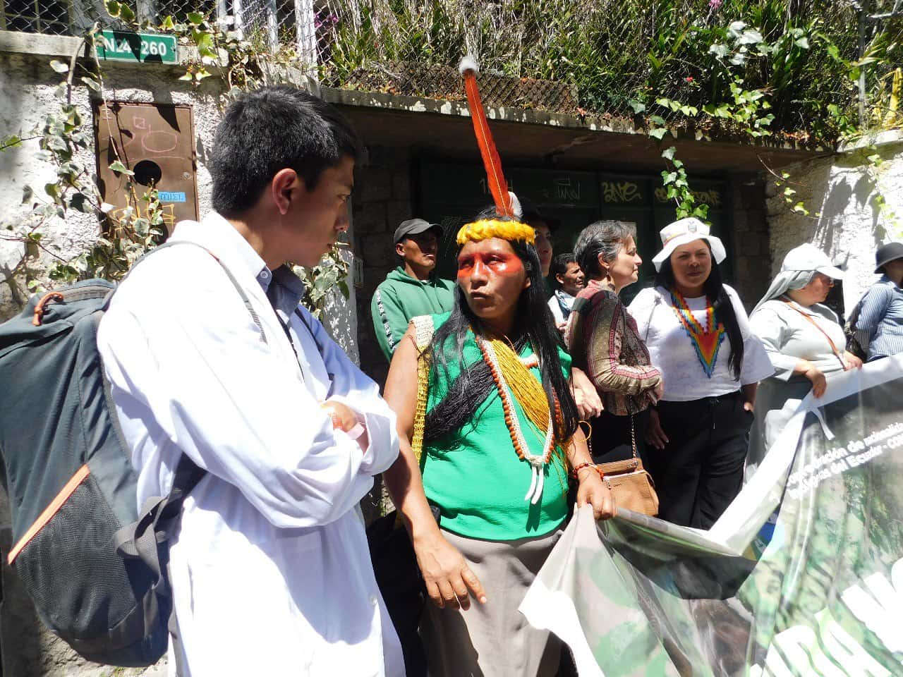 A rebel scientist chats with an indigenous protester during a rally