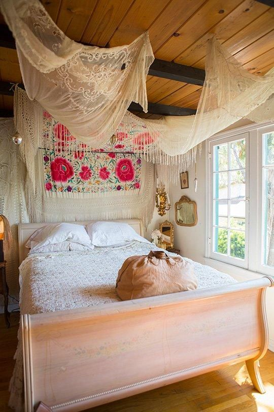 This sleigh bed room has bohemian design elements.