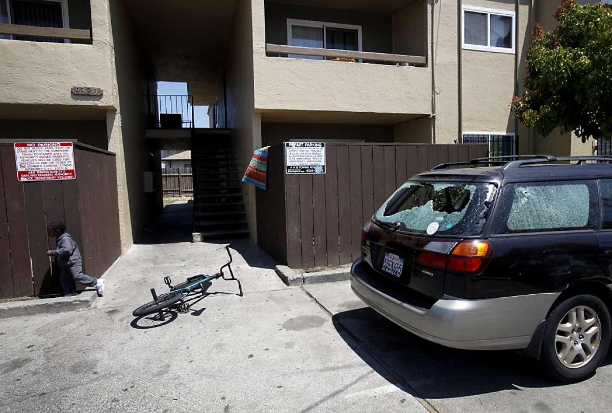 A Subaru has shattered windows from the gunfire that killed Najon Jackson, 16, outside this apartment complex in Oakland, Calif., Monday, August 1, 2011. Jackson was shot and killed outside the apartment Saturday night.