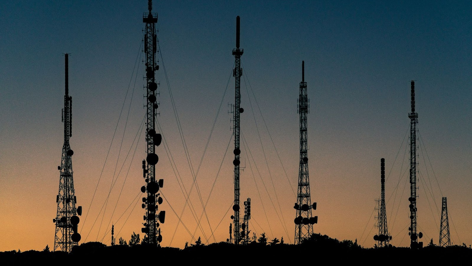 Telecom and satellite poles at sunset