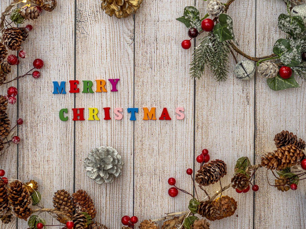 Colorful letters on a wooden table  arranged to spell "Merry Christmas"