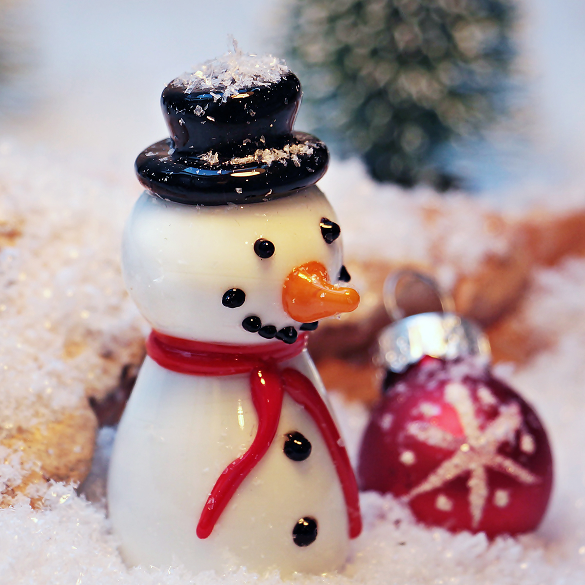 small white glass smiling snowman with red scarf