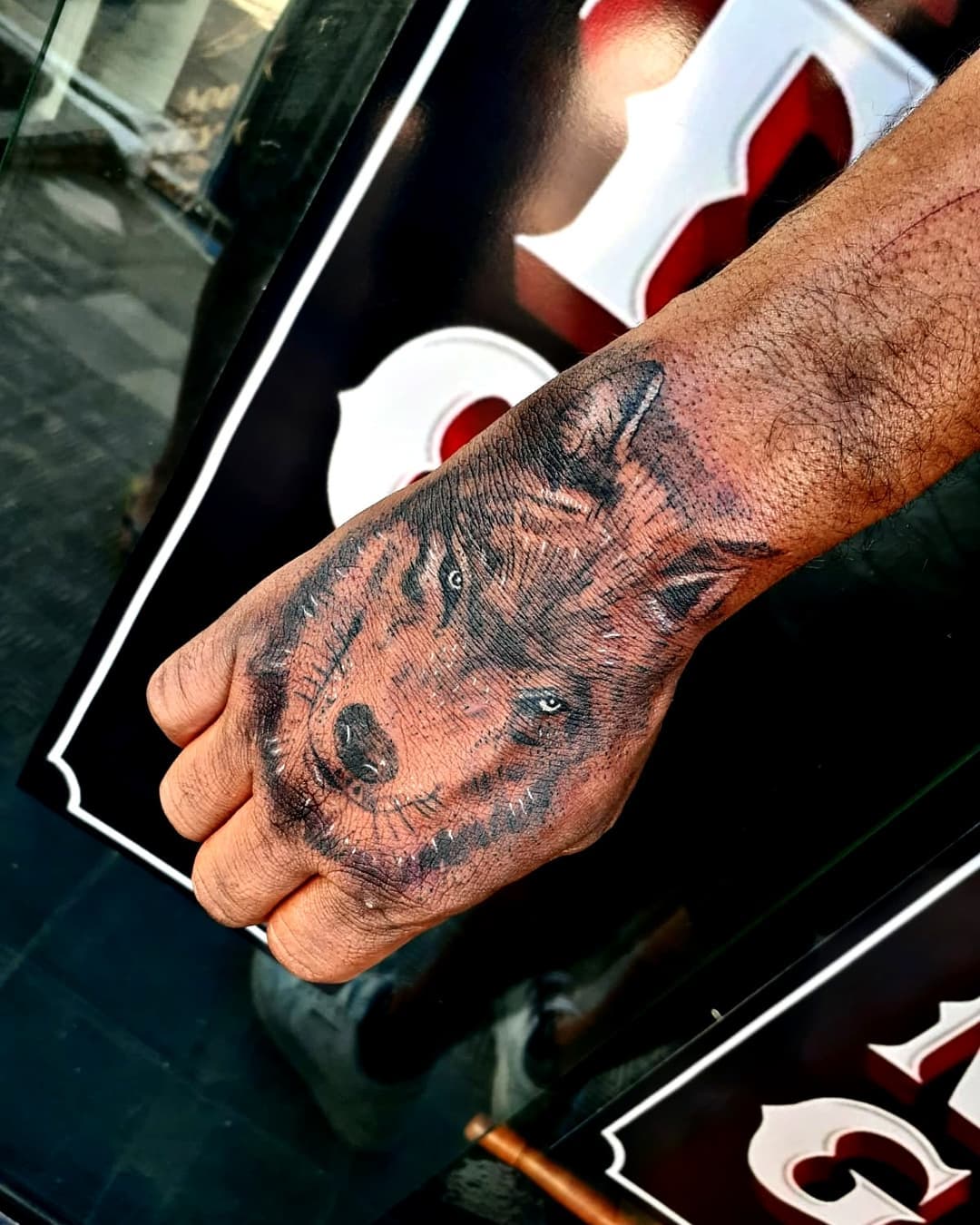 Black Wolf With White Shaded Tattoo On Hand