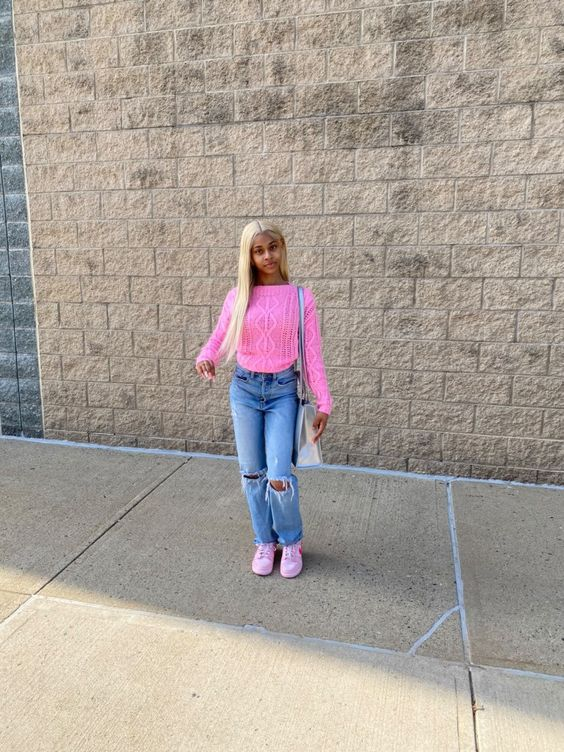 Girl on jean and top shows off her iconic triple pink dunk look