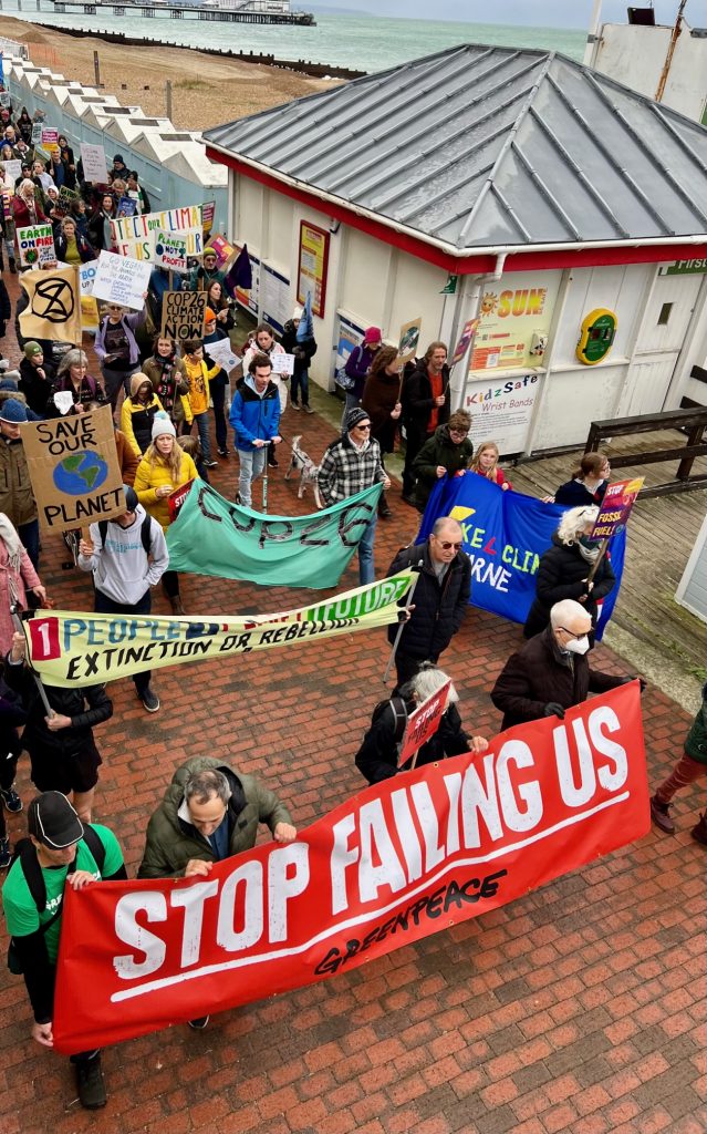 Eastbourne residents participate in a protest march to recognise COP26