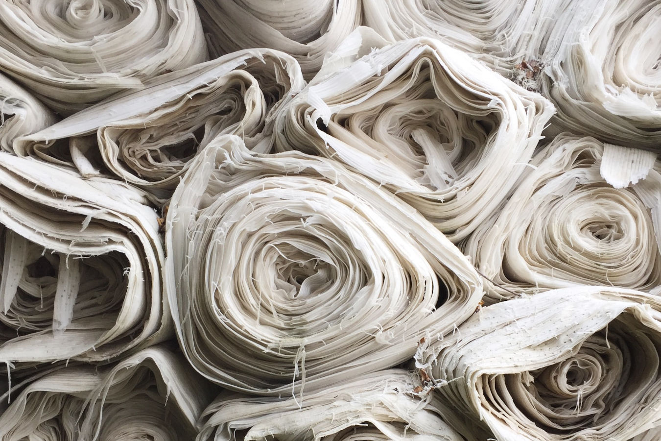 Stack of white fabric rolls